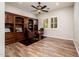 This stylish office includes hardwood floors, a built-in bookcase, and windows with wood shutters at 13221 W Rincon Dr, Sun City West, AZ 85375