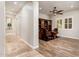 Inviting office with hardwood floors, a built-in bookcase, and natural light from shuttered windows at 13221 W Rincon Dr, Sun City West, AZ 85375