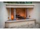 Elegant outdoor fireplace with stone columns, a herringbone brick interior, and a cozy ambiance at 13221 W Rincon Dr, Sun City West, AZ 85375