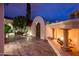 Outdoor fireplace and deck area with lush greenery and an artistic deer statue at 13221 W Rincon Dr, Sun City West, AZ 85375