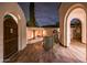 Cozy outdoor fireplace on a wood deck framed by stucco archways at 13221 W Rincon Dr, Sun City West, AZ 85375
