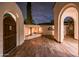 Cozy outdoor fireplace on a wood deck framed by stucco archways at 13221 W Rincon Dr, Sun City West, AZ 85375