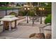 This cozy outdoor patio has a stone fireplace, seating area and wrought iron fencing at 13221 W Rincon Dr, Sun City West, AZ 85375