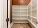 Walk-in pantry featuring adjustable shelving and a cabinet for storing food items at 13221 W Rincon Dr, Sun City West, AZ 85375