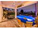 A covered patio overlooking a beautiful pool, hot tub and meticulously maintained landscaping at 13221 W Rincon Dr, Sun City West, AZ 85375