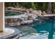Luxury pool with stone accents and cascading waterfall feature at 13221 W Rincon Dr, Sun City West, AZ 85375
