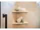 Elegant shower features built-in shelves adorned with decorative accents, adding a touch of sophistication at 13221 W Rincon Dr, Sun City West, AZ 85375