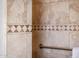Tile shower stall with decorative tile, showcasing meticulous attention to detail and creating a refreshing space at 13221 W Rincon Dr, Sun City West, AZ 85375