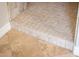Shower entrance featuring tile flooring, showcasing a seamless transition and quality craftsmanship in this bathroom at 13221 W Rincon Dr, Sun City West, AZ 85375