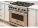 Stainless steel Viking stove surrounded by white cabinets at 13221 W Rincon Dr, Sun City West, AZ 85375
