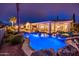 Stunning backyard pool area with lush landscaping, spa, and covered patio with seating at 13221 W Rincon Dr, Sun City West, AZ 85375