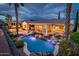 Resort-style backyard featuring a lagoon-style pool with spa, and covered patio with seating at 13221 W Rincon Dr, Sun City West, AZ 85375