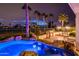 Resort-style backyard featuring a lagoon-style pool with swim-up bar and lush tropical landscaping at 13221 W Rincon Dr, Sun City West, AZ 85375