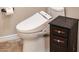 Modern toilet with advanced features, complemented by a decorative side table for added convenience at 13221 W Rincon Dr, Sun City West, AZ 85375