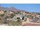 Elevated view of a well-planned community set against a mountain range, with winding roads and diverse home styles at 13227 N Mimosa Dr # 107, Fountain Hills, AZ 85268