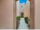 Entrance with desert landscaping alongside a walkway between buildings at 13227 N Mimosa Dr # 107, Fountain Hills, AZ 85268