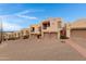View of stucco homes, each with a two-car garage, with brick-paved driveway at 13227 N Mimosa Dr # 107, Fountain Hills, AZ 85268