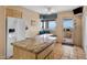 Bright kitchen with a large island, granite counters, and beautiful desert views from the window at 13227 N Mimosa Dr # 107, Fountain Hills, AZ 85268