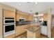 Spacious kitchen with wooden cabinets, granite countertops, tiled flooring and modern appliances at 13227 N Mimosa Dr # 107, Fountain Hills, AZ 85268