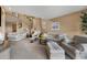 Cozy living room features a fireplace, staircase, and plush seating arrangements at 13227 N Mimosa Dr # 107, Fountain Hills, AZ 85268