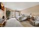 The main bedroom features soft carpet, a tv, and a door leading to a private patio at 13227 N Mimosa Dr # 107, Fountain Hills, AZ 85268