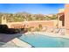 Inviting community pool with lounge chairs surrounded by desert landscape at 13227 N Mimosa Dr # 107, Fountain Hills, AZ 85268