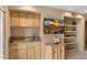 Features a wet bar with wooden cabinets, granite counters, flatscreen tv, and shelving at 13227 N Mimosa Dr # 107, Fountain Hills, AZ 85268