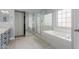 Bright bathroom featuring a shower, large soaking tub and large sliding closet doors at 13312 W Edgemont Ave, Goodyear, AZ 85395