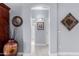 Hallway with decorative vase and artwork; doorway leading to additional rooms at 13312 W Edgemont Ave, Goodyear, AZ 85395