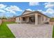 Spacious backyard featuring a covered patio, lush green grass, and a paved area perfect for outdoor gatherings at 13603 W Remuda Dr, Peoria, AZ 85383