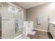 Bathroom featuring a glass-enclosed shower, a soaking tub, and a vanity with double sinks at 13603 W Remuda Dr, Peoria, AZ 85383