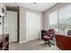 Bedroom showcasing a built-in closet with sliding doors, a window providing natural light, and neutral paint color at 13603 W Remuda Dr, Peoria, AZ 85383