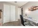 Bedroom featuring neutral walls and carpet, with built-in closet with sliding doors and a table with a puzzle on it at 13603 W Remuda Dr, Peoria, AZ 85383