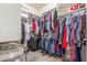 Walk-in closet featuring built-in shelving and racks for organized storage of clothing, shoes and other personal items at 13603 W Remuda Dr, Peoria, AZ 85383