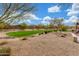 Landscaped common area showcases a green lawn and trees, fostering a sense of community and relaxation at 13603 W Remuda Dr, Peoria, AZ 85383