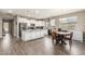 Spacious kitchen with white cabinetry, granite countertops, stainless steel appliances, and a dining area at 13603 W Remuda Dr, Peoria, AZ 85383