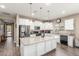 Bright kitchen featuring white cabinets, granite countertops, stainless steel appliances, and a large island at 13603 W Remuda Dr, Peoria, AZ 85383