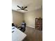 Cozy home office with a ceiling fan, cabinet, and comfortable chairs offers a productive workspace at 13603 W Remuda Dr, Peoria, AZ 85383