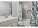 This bathroom showcases a tiled wall, shower with tub, and decorative shower curtain at 1372 N Zane Dr, Chandler, AZ 85226