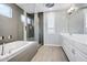 Sleek bathroom featuring a glass-enclosed shower, soaking tub and double sink vanity at 1372 N Zane Dr, Chandler, AZ 85226