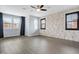 Spacious bedroom featuring three windows, ceiling fan and accent wall at 1372 N Zane Dr, Chandler, AZ 85226