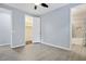 Light blue bedroom with wood-look tile floors, ceiling fan and closet and bathroom access at 1372 N Zane Dr, Chandler, AZ 85226