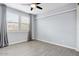 Bedroom features two windows for natural light, neutral wall color and wood-look tile flooring at 1372 N Zane Dr, Chandler, AZ 85226