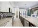 Modern kitchen showcasing granite countertops, stainless steel appliances, and a walk-in pantry at 1372 N Zane Dr, Chandler, AZ 85226