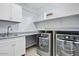 Convenient laundry room with modern washer, dryer, sink, and ample cabinetry at 1372 N Zane Dr, Chandler, AZ 85226