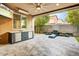 Beautiful outdoor patio with built-in grill, TV, fire pit and water feature at 1372 N Zane Dr, Chandler, AZ 85226