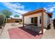 A covered patio, with brick accents, overlooks a low-maintenance backyard at 1510 E Wescott Dr, Phoenix, AZ 85024