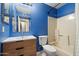 This updated bathroom features a new sink vanity, bathtub, and blue accent wall at 1510 E Wescott Dr, Phoenix, AZ 85024