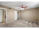 This bedroom features neutral walls, carpet, closet, and a ceiling fan for comfort at 1510 E Wescott Dr, Phoenix, AZ 85024