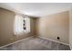 Cozy bedroom with plush carpeting, neutral tones, and a bright window for natural light at 1510 E Wescott Dr, Phoenix, AZ 85024